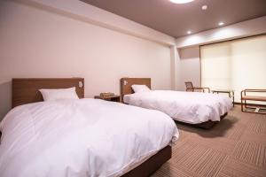 Postel nebo postele na pokoji v ubytování Hotel Umenoyu