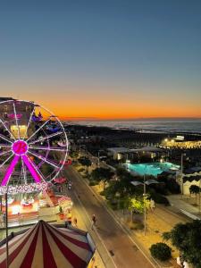 a ferris wheel in a city with a carnival at CRIMA LEDA LUXURY in Misano Adriatico