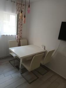 a white table and chairs in a room at Stars Palace Vodice in Vodice