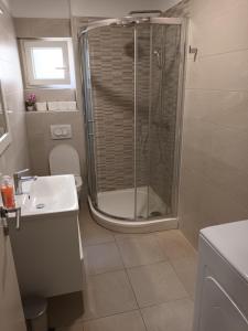 a bathroom with a shower and a toilet and a sink at Stars Palace Vodice in Vodice +25 photos