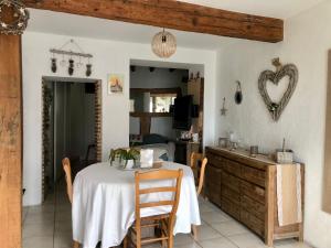 a dining room with a table and a kitchen at Maison de village aux portes de Toulouse in Fenouillet +18 photos