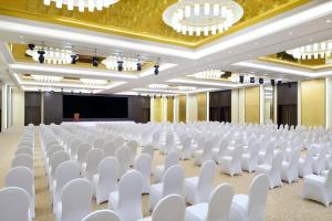an empty hall with white chairs and a projection screen at Radisson Blu Hotel and Convention Center, Riyadh Minhal in Riyadh +87 photos