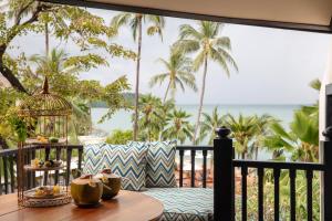 a table on a balcony with a view of the ocean at Anantara Bophut Koh Samui Resort in Bophut