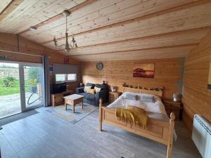 a bedroom with a bed and a couch in a room at Rife Lodges in Arundel +120 photos
