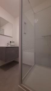 a glass shower in a bathroom with a sink at Chambre d'hôte, la b&w in Liège