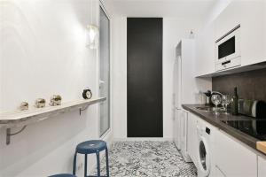 a white kitchen with a sink and a counter at Apartment in downtown Barcelona - Vintage in Barcelona