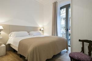 Posteľ alebo postele v izbe v ubytovaní Apartment in downtown Barcelona - Vintage
