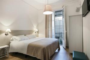 Posteľ alebo postele v izbe v ubytovaní Apartment in downtown Barcelona - Vintage