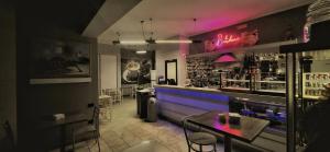 a restaurant with a bar with purple lights at Motel Karibe in Fratta Polesine