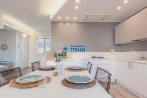 a kitchen and dining room with a table and chairs at Condominio Aquileia in Lido di Jesolo
