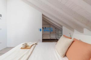 a bedroom with a large white bed in a room at Condominio Aquileia in Lido di Jesolo