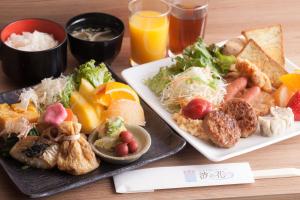 a table with two plates of food and drinks at HOTEL MYSTAYS PREMIER Kanazawa in Kanazawa