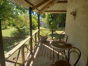 a patio with a table and chairs on a porch at Emerald Hill Cottage in Mount Pleasant