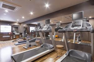 a gym with several treadmills and a treadmill at HOTEL MYSTAYS PREMIER Kanazawa in Kanazawa