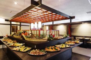 a buffet line with many plates of food at HOTEL MYSTAYS PREMIER Kanazawa in Kanazawa