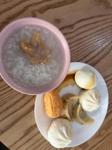 a bowl of soup with mushrooms and garlic on a plate at Shanghai Guiwu Village Near Disney Resort in Shanghai