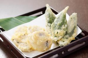 a plate of food with potatoes and green vegetables at HOTEL MYSTAYS PREMIER Kanazawa in Kanazawa