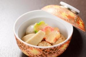 a bowl of food with corn chips and a spoon at HOTEL MYSTAYS PREMIER Kanazawa in Kanazawa