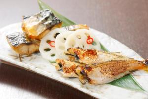 a plate of food with fish and other foods at HOTEL MYSTAYS PREMIER Kanazawa in Kanazawa