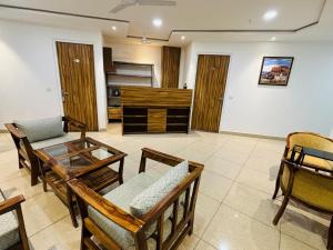 a living room with a glass table and chairs at Hotel Runway Inn in Jodhpur