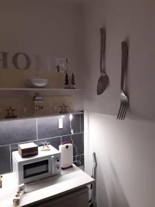 a kitchen with a counter with a microwave and utensils at Schalke GelsenkirchenSie wollen Günstig und KomfortabelWir auch für unsere bestenDie Gäste in Gelsenkirchen +28 photos