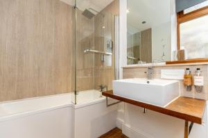 a bathroom with a sink and a shower at The Gower Hotel in Swansea +89 photos
