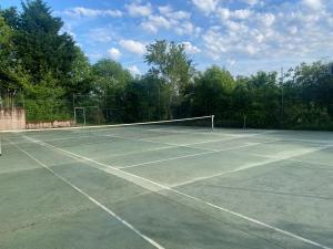 a tennis court with a net on it at Quinta de Ribas in Amarante