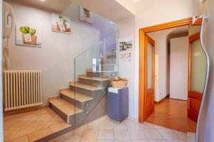 a hallway with stairs in a room with a door at Casa Vacanza da Nicolo in Pallanza