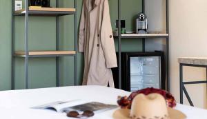 a room with a table with a hat and a book at Hotel Shoshana - Adults Only in Eilat