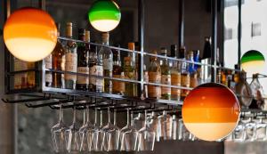 a bunch of bottles and glasses on a bar at Hotel Shoshana - Adults Only in Eilat
