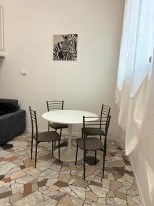 una mesa y sillas en una habitación con una foto de cebra en Corsico Comfort Loft - Affitti Brevi Italia, en Corsico 5 fotos más