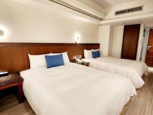 Postel nebo postele na pokoji v ubytování Hub Hotel Kaohsiung Cisian Branch