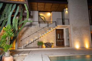 a house with a staircase and a swimming pool at DECU DOWNTOWN in Mérida