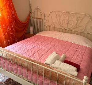 - une chambre avec un lit doté de draps roses et de serviettes blanches dans l'établissement Mona Lisà, à Larissa