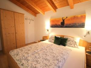 A bed or beds in a room at Apartment Piz Munschuns by Interhome
