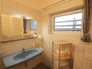 A bathroom at Apartment Piz Munschuns by Interhome