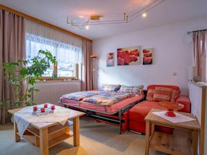 a living room with a couch and a bed at Apartment Bichleregg by Interhome in Sautens