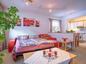 a living room with a bed and a table at Apartment Bichleregg by Interhome in Sautens +36 photos