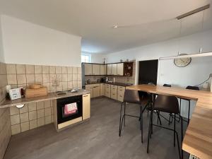 a large kitchen with a table and chairs in it at Gästehaus WEIN-Traum in Horitschon