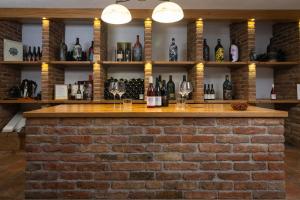 a brick bar with wine glasses on a brick wall at BRIC Wine & Relax in Vogrsko