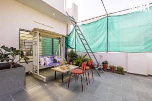 a room with a table and chairs and a bed at StayVista at Ikigai - Pool, AC & Terrace in Udaipur