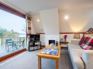 a living room with a couch and a table at Chalet Lothlorien Lodge 4 by Interhome in Spean Bridge +67 photos