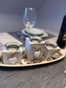 a plate with three candles on a table at Strandgut in Fehmarn