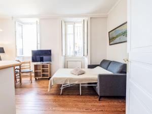 a living room with a couch and a table at Apartment Villa La Concha-2 by Interhome in Saint-Jean-de-Luz
