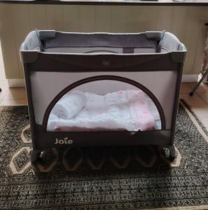 a baby crib with an open door in a room at Twelveon1st in Cape Town
