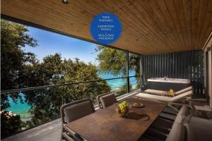 a dining room with a table and a view of the ocean at Adrialux Camping Mobile Homes in Selce