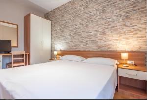 Postel nebo postele na pokoji v ubytování Hotel Velus