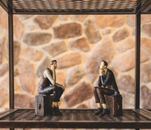 two figurines sitting on a shelf in front of a wall at Hotel Shoshana - Adults Only in Eilat +71 photos