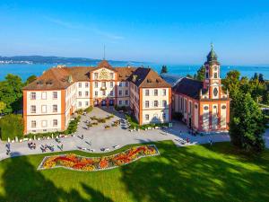 an aerial view of a large building with a clock tower at Direkt am See - Bodenseeresidenz in Bodman in Bodman-Ludwigshafen