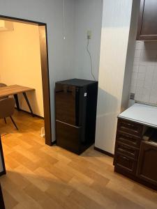 an empty kitchen with a table and a refrigerator at Guesthouse NALUノ道 in Kobe +28 photos